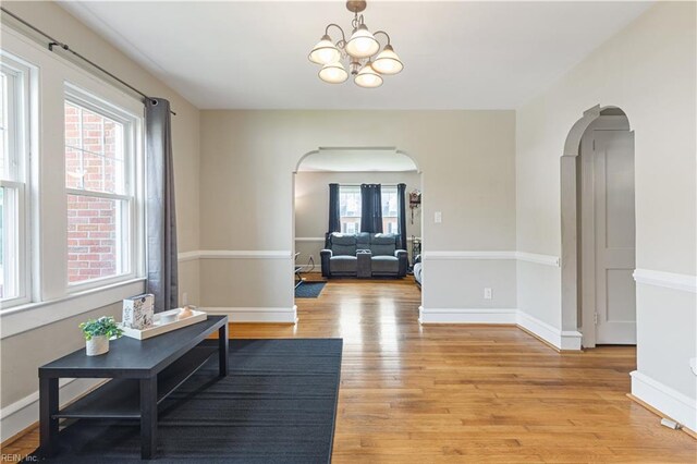133 Chesterfield Rd, Hampton, VA 23661 - living area with arched walkways, light wood-style floors, a chandelier, and baseboards