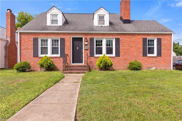 133 Chesterfield Rd, Hampton, VA 23661 - cape cod house with brick siding, a front lawn, and a chimney