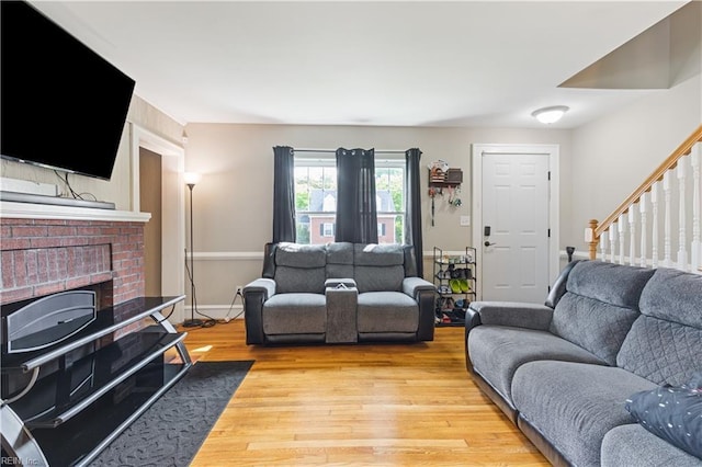 133 Chesterfield Rd, Hampton, VA 23661 - living area with light wood-type flooring, a brick fireplace, stairway, and baseboards