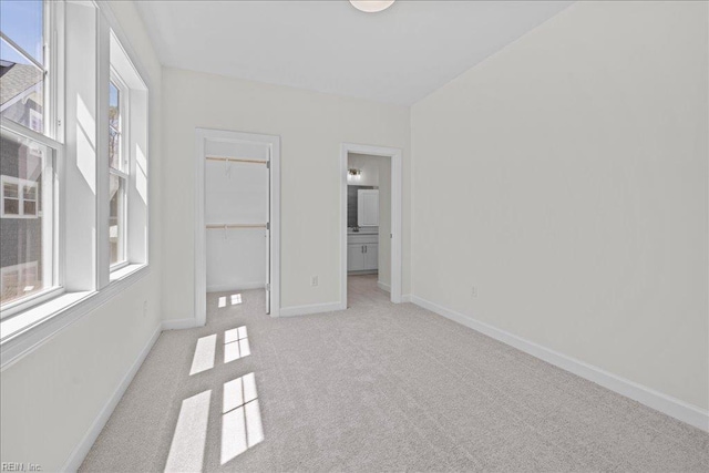 206 84th St Unit A, Virginia Beach, VA 23451 - unfurnished bedroom with carpet, baseboards, a closet, a walk in closet, and connected bathroom