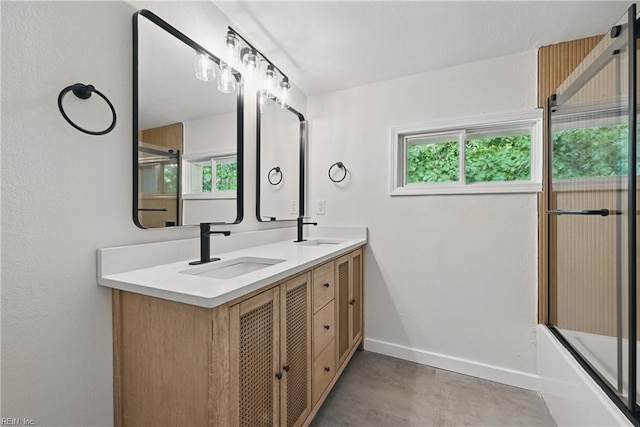 1202 Land St, Norfolk, VA 23502 - full bathroom with baseboards, double vanity, enclosed tub / shower combo, and concrete flooring
