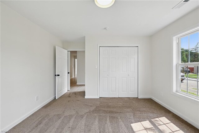 1202 Land St, Norfolk, VA 23502 - unfurnished bedroom featuring carpet, a closet, and baseboards