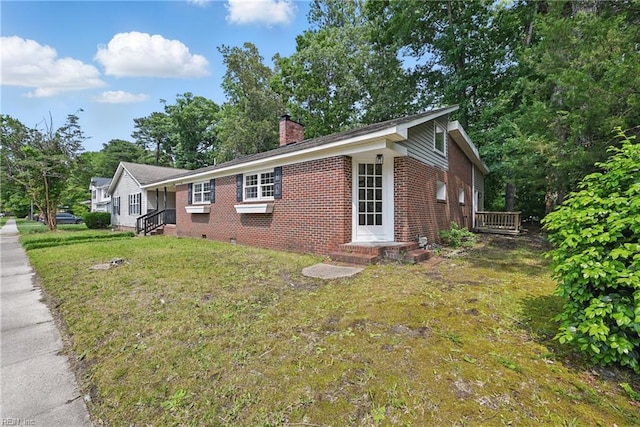 1202 Land St, Norfolk, VA 23502 - view of property exterior with brick siding, a chimney, a yard, and crawl space