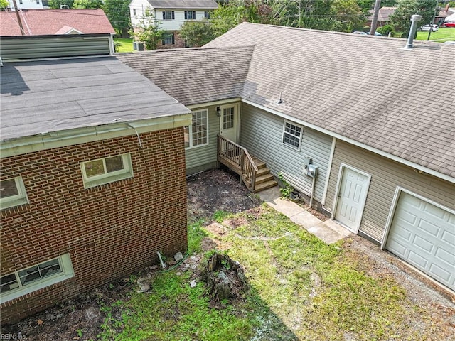 1202 Land St, Norfolk, VA 23502 - back of property featuring a shingled roof and brick siding