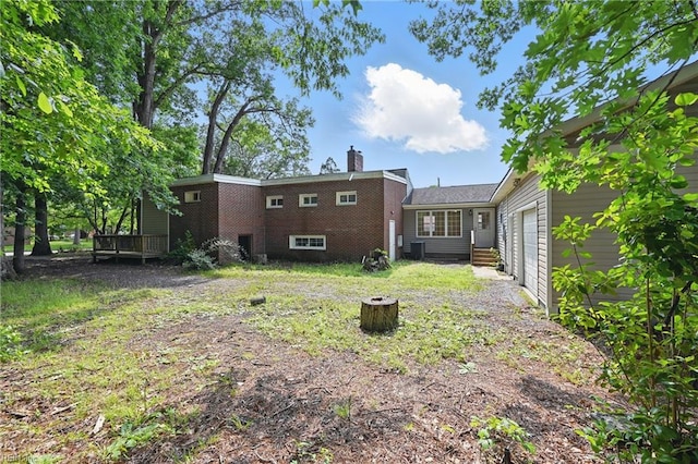 1202 Land St, Norfolk, VA 23502 - rear view of house featuring a garage, central air condition unit, a chimney, and a deck