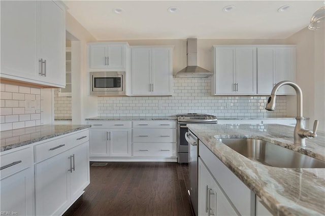 2221 Patrick Dr, Suffolk, VA 23435 - kitchen featuring wall chimney range hood, stainless steel appliances, a sink, white cabinetry, and recessed lighting