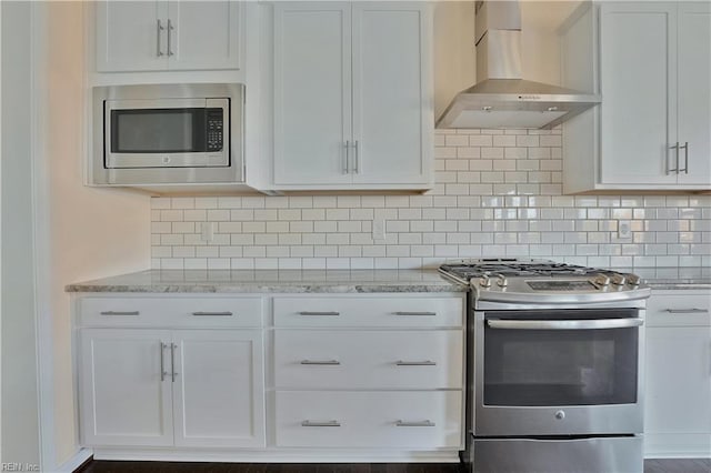 2221 Patrick Dr, Suffolk, VA 23435 - kitchen with stainless steel appliances, wall chimney range hood, white cabinetry, and light stone countertops