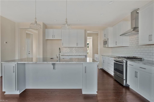 2221 Patrick Dr, Suffolk, VA 23435 - kitchen with appliances with stainless steel finishes, wall chimney range hood, tasteful backsplash, a sink, and a kitchen island with sink