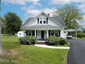 96 Doctors Creek Rd, New Point, VA 23125 - bungalow-style home with a porch, a carport, a front yard, a chimney, and driveway