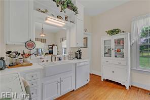 96 Doctors Creek Rd, New Point, VA 23125 - kitchen featuring white dishwasher, light wood-style floors, light countertops, and white cabinets