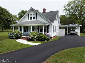96 Doctors Creek Rd, New Point, VA 23125 - view of front of property with covered porch, a front yard, a chimney, and driveway