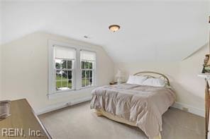 96 Doctors Creek Rd, New Point, VA 23125 - carpeted bedroom featuring vaulted ceiling and baseboards