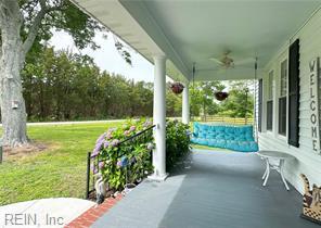 96 Doctors Creek Rd, New Point, VA 23125 - porch featuring a ceiling fan and a yard