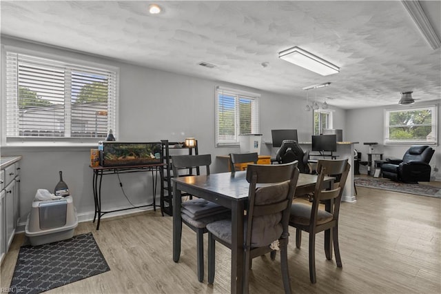 1201 Hale Dr, Hampton, VA 23663 - dining space with light wood-style flooring and a textured ceiling
