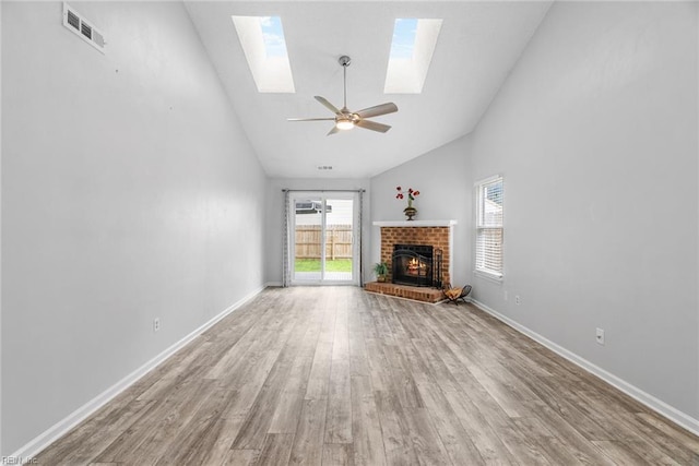 1016 Gauguin Dr, Virginia Beach, VA 23454 - unfurnished living room with a skylight, wood finished floors, a brick fireplace, high vaulted ceiling, and a ceiling fan
