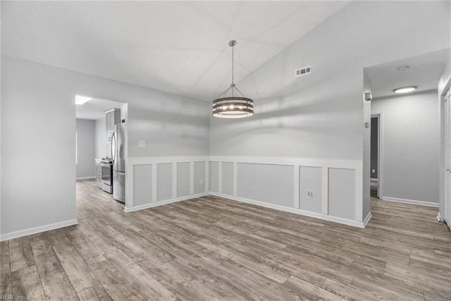 1016 Gauguin Dr, Virginia Beach, VA 23454 - spare room with wood finished floors, a wainscoted wall, a chandelier, a decorative wall, and high vaulted ceiling