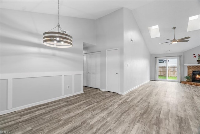 1016 Gauguin Dr, Virginia Beach, VA 23454 - unfurnished living room with high vaulted ceiling, a chandelier, wood finished floors, a skylight, and a ceiling fan