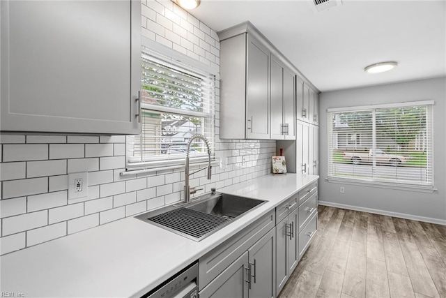 1016 Gauguin Dr, Virginia Beach, VA 23454 - kitchen with gray cabinetry, a sink, baseboards, light countertops, and decorative backsplash