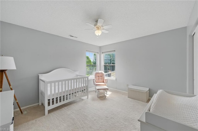 3507 Sedgefield St, Suffolk, VA 23435 - carpeted bedroom featuring baseboards, a ceiling fan, a nursery area, and a textured ceiling