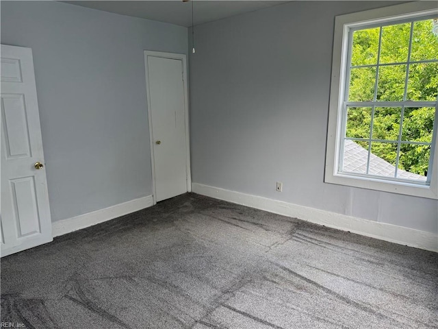 215 E Howard St, Hampton, VA 23663 - spare room with healthy amount of natural light, dark carpet, and baseboards