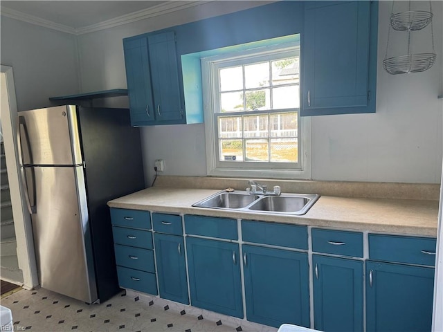 215 E Howard St, Hampton, VA 23663 - kitchen featuring blue cabinets, freestanding refrigerator, a sink, light countertops, and ornamental molding