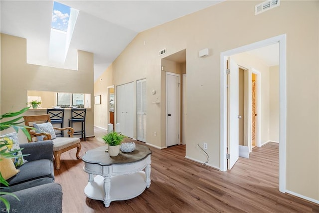 3912 Pollypine Dr, Virginia Beach, VA 23452 - living area featuring wood finished floors, high vaulted ceiling, a skylight, and baseboards
