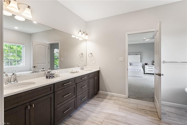 5060 Riverfront Dr, Suffolk, VA 23434 - bathroom with connected bathroom, double vanity, baseboards, and recessed lighting