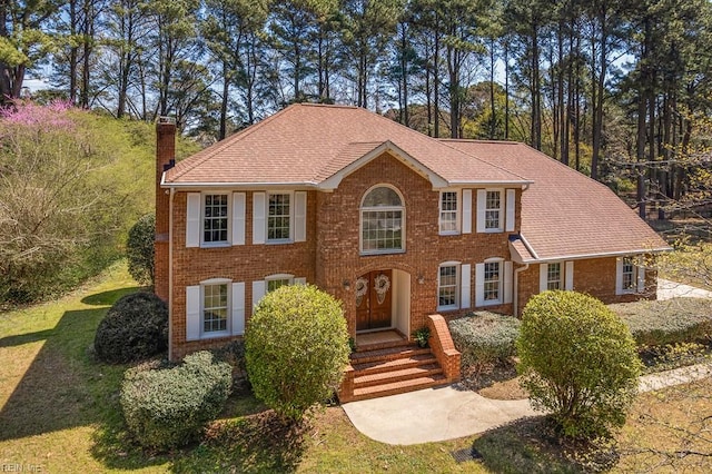 1328 Harris Rd, Virginia Beach, VA 23452 - view of front of house with a chimney, brick siding, and a front yard