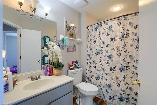 2117 King James Ct, Carrollton, VA 23314 - bathroom featuring vanity, toilet, a shower with shower curtain, a chandelier, and wood finished floors