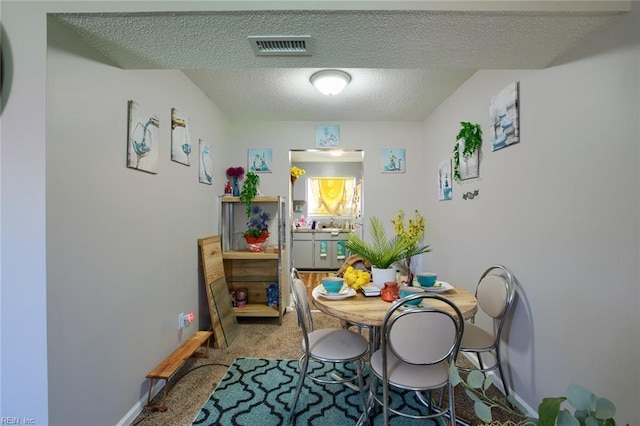 2117 King James Ct, Carrollton, VA 23314 - dining space featuring carpet floors, a textured ceiling, and baseboards