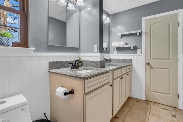5260 Iowa Ave, Norfolk, VA 23513 - bathroom featuring toilet, a wainscoted wall, double vanity, and tile patterned flooring