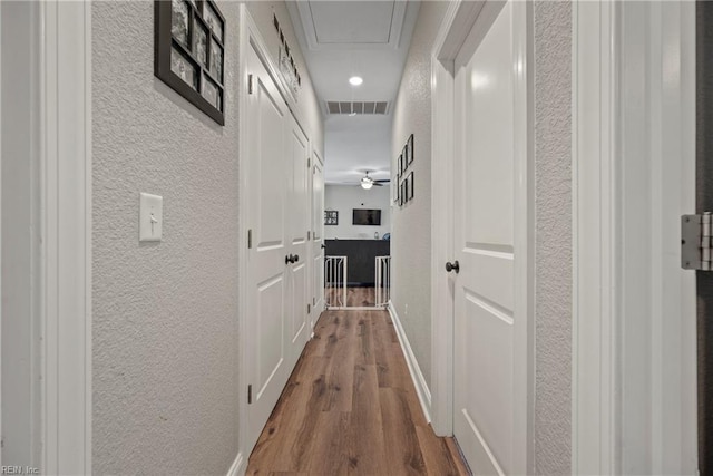 554 Trotman Rd, Camden, NC 27921 - corridor with a textured wall, attic access, and wood finished floors