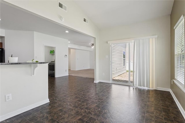 648 Sea Turtle Way, Newport News, VA 23601 - unfurnished living room featuring dark stone finish flooring, healthy amount of natural light, and ceiling fan