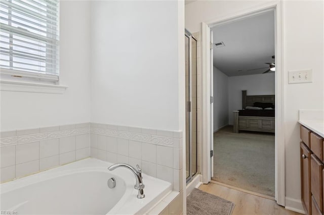 648 Sea Turtle Way, Newport News, VA 23601 - ensuite bathroom featuring a garden tub, vanity, a ceiling fan, a shower stall, and wood finished floors