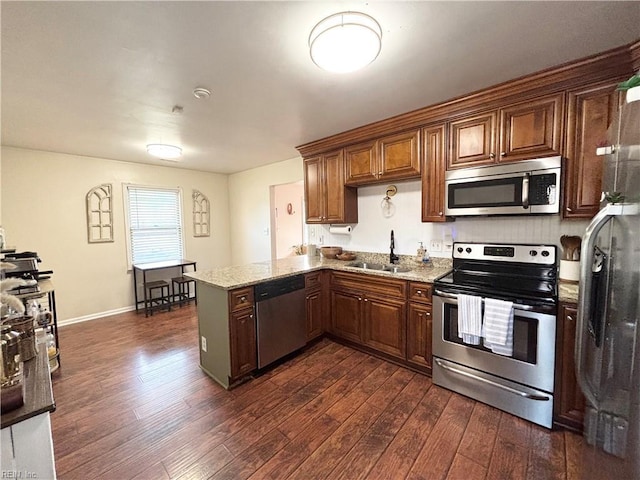 1135 Virginia Ave, Chesapeake, VA 23324 - kitchen with appliances with stainless steel finishes, a sink, a peninsula, and dark wood finished floors