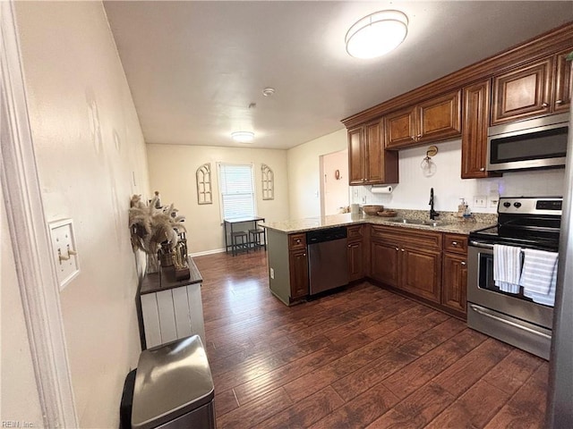 1135 Virginia Ave, Chesapeake, VA 23324 - kitchen with stainless steel appliances, a sink, dark wood finished floors, a peninsula, and stone counters
