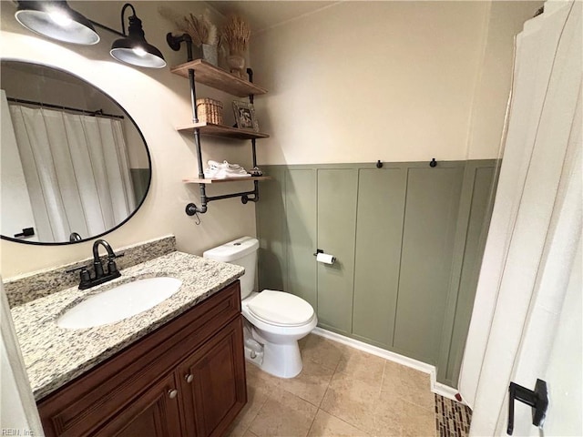 1135 Virginia Ave, Chesapeake, VA 23324 - full bathroom featuring vanity, toilet, a wainscoted wall, and tile patterned flooring