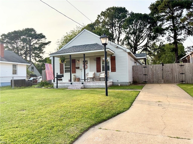 1135 Virginia Ave, Chesapeake, VA 23324 - bungalow-style home featuring a porch, a gate, a shingled roof, and concrete driveway