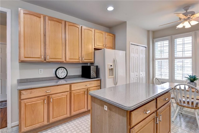 6716 Tarpleys Tavern Rd, Williamsburg, VA 23188 - kitchen with white refrigerator with ice dispenser, a ceiling fan, light flooring, a kitchen island, and light countertops