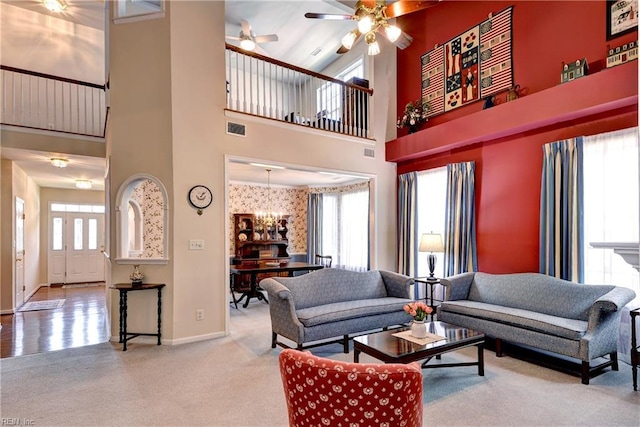 6716 Tarpleys Tavern Rd, Williamsburg, VA 23188 - carpeted living area featuring a towering ceiling, a ceiling fan, and a chandelier