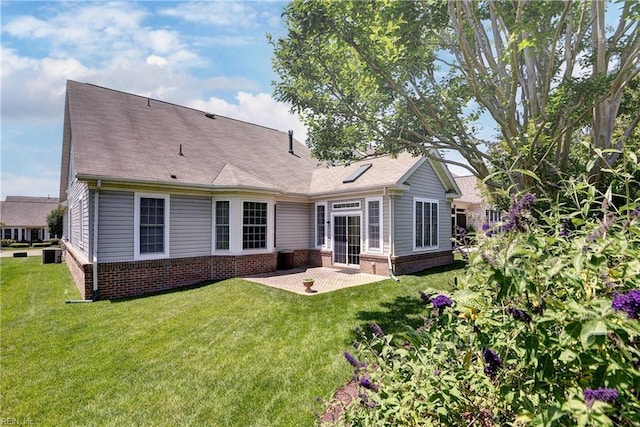 6716 Tarpleys Tavern Rd, Williamsburg, VA 23188 - back of house with brick siding, a patio, and a yard