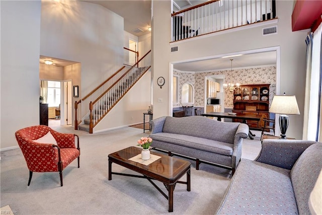 6716 Tarpleys Tavern Rd, Williamsburg, VA 23188 - living area featuring a towering ceiling, stairway, a chandelier, wallpapered walls, and carpet flooring