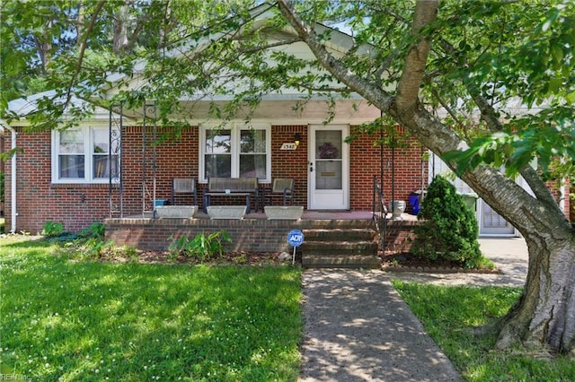 1348 Carlton Ct, Norfolk, VA 23503 - view of front facade featuring a porch, brick siding, and a front yard