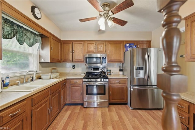 1348 Carlton Ct, Norfolk, VA 23503 - kitchen with appliances with stainless steel finishes, a sink, brown cabinets, light countertops, and ceiling fan