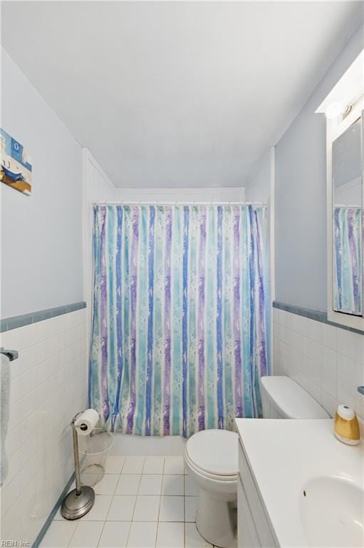 1348 Carlton Ct, Norfolk, VA 23503 - full bath with tile walls, toilet, vanity, wainscoting, and tile patterned flooring