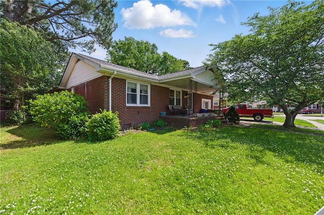 1348 Carlton Ct, Norfolk, VA 23503 - view of side of property with brick siding, a lawn, and a porch