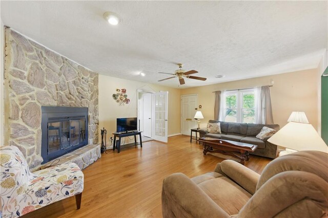 1348 Carlton Ct, Norfolk, VA 23503 - living area with a textured ceiling, a fireplace, wood finished floors, a ceiling fan, and baseboards