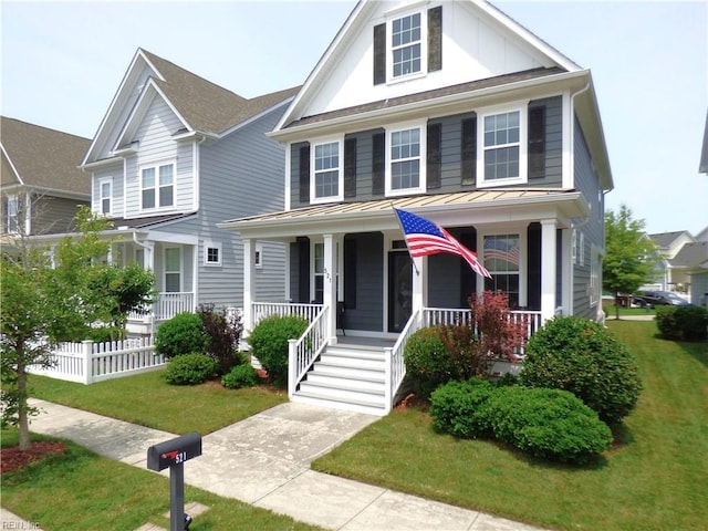 521 Simpson Ln, Chesapeake, VA 23323 - view of front facade featuring a standing seam roof, a porch, metal roof, and board and batten siding