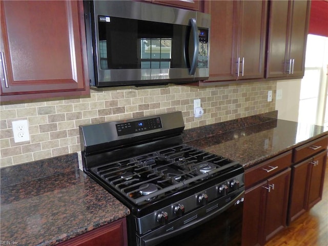 521 Simpson Ln, Chesapeake, VA 23323 - kitchen featuring stainless steel appliances, dark stone counters, and backsplash