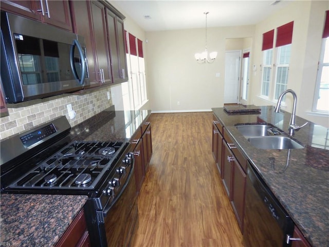 521 Simpson Ln, Chesapeake, VA 23323 - kitchen featuring stainless steel microwave, gas stove, a sink, black dishwasher, and wood finished floors